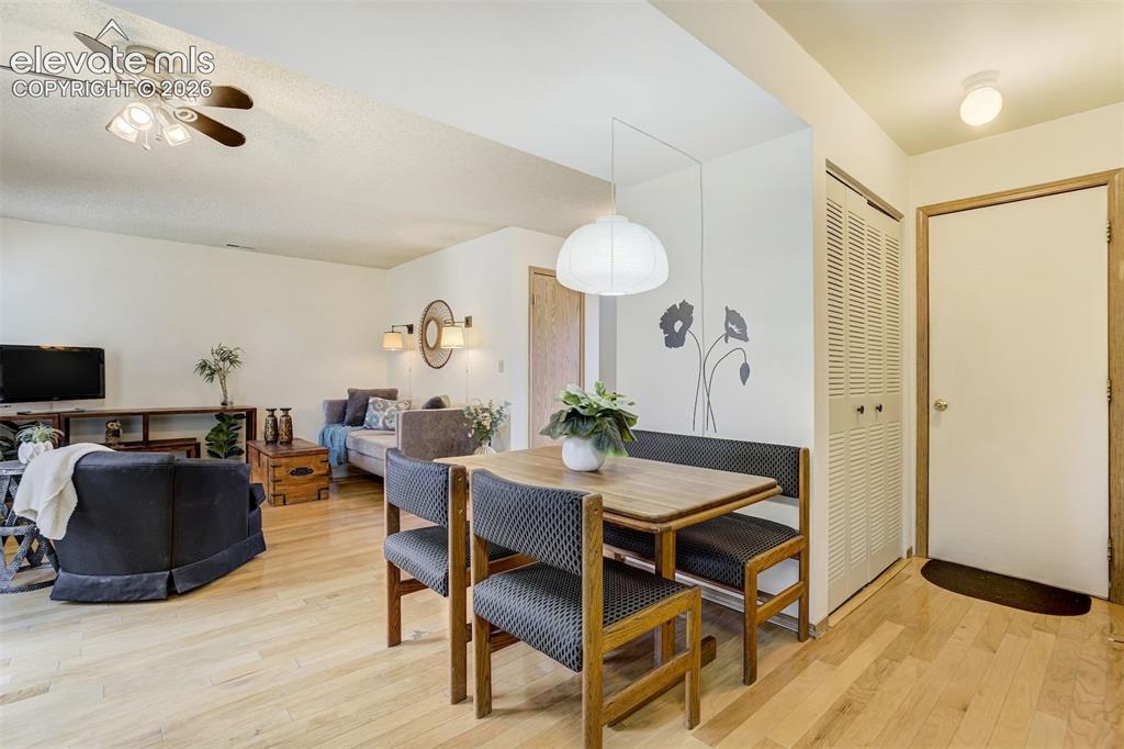 Image 14 of 50: Open-concept living space featuring wood-finish flooring, a contemporary ce