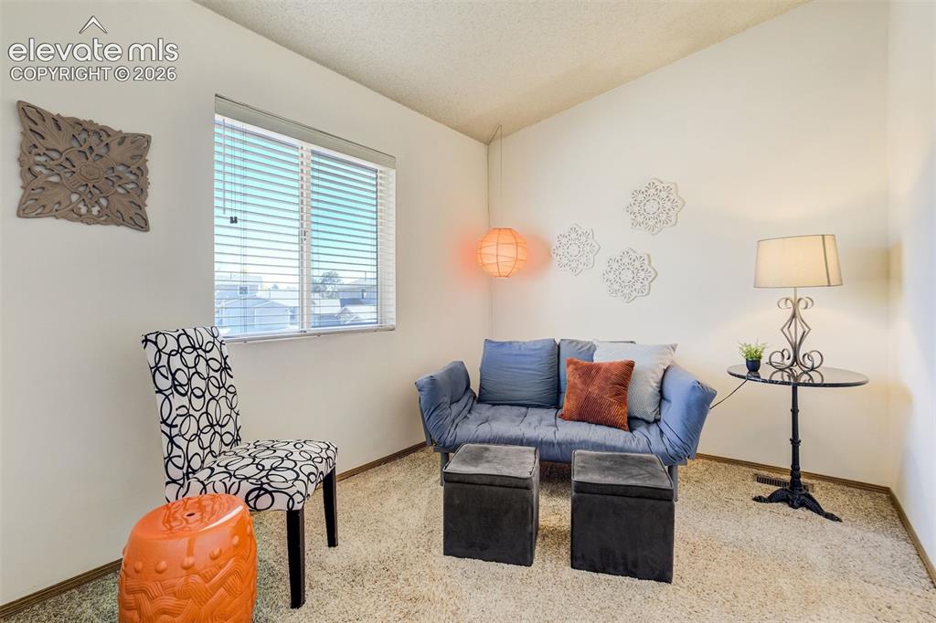 Image 20 of 50: Light-colored wall finishes, window with blinds, and textured ceiling