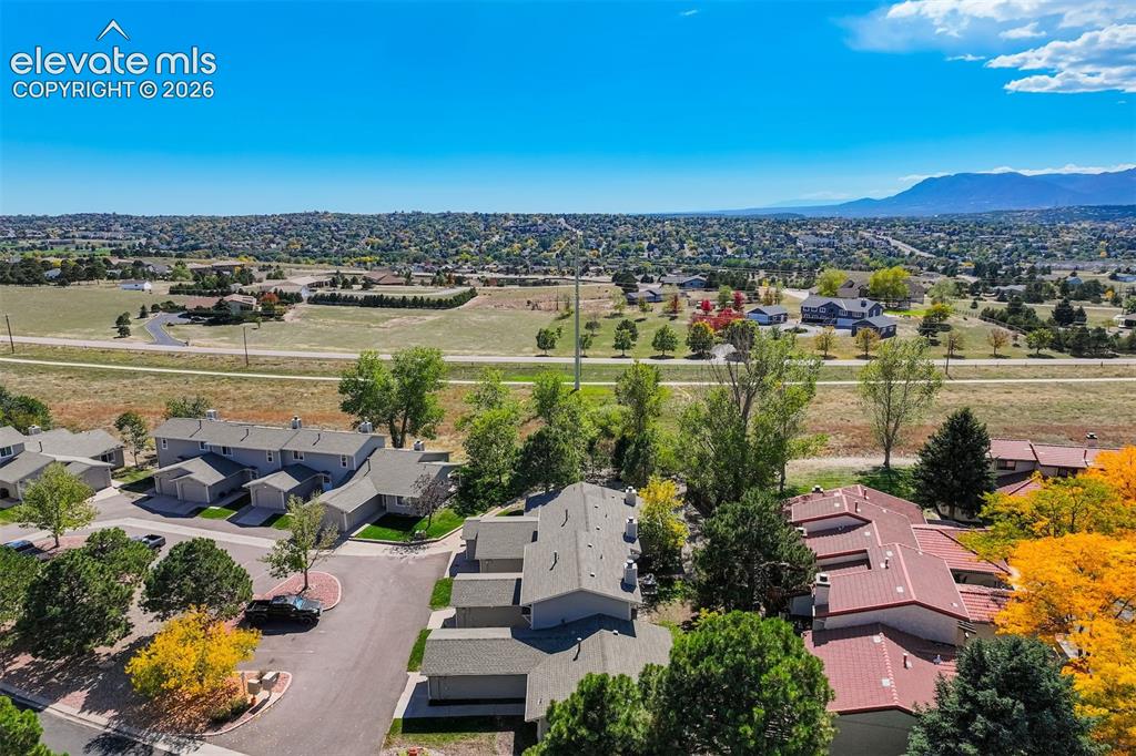 Image 35 of 50: Townhome community with varied rooflines and mature landscaping
