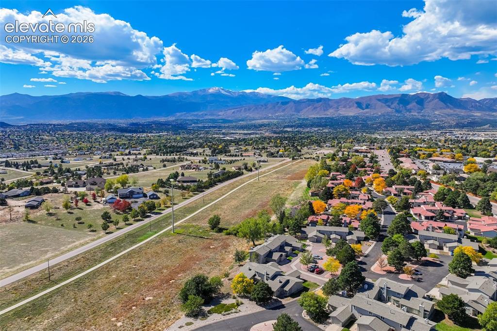 Image 38 of 50: Expansive mountain backdrop with a developed community featuring townhomes