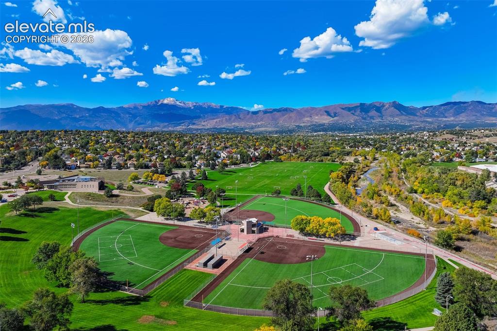 Image 41 of 50: Baseball and soccer fields with manicured turf, surrounded by mature trees,