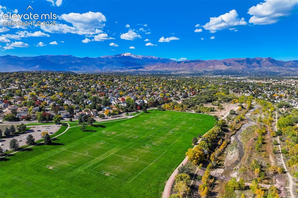 Image 47 of 50: Expansive green athletic fields with marked sports areas