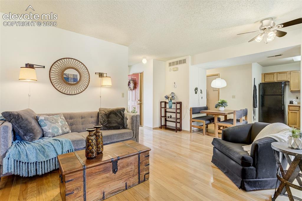 Image 7 of 50: Hardwood flooring throughout, recessed lighting in the kitchen, and a ceili