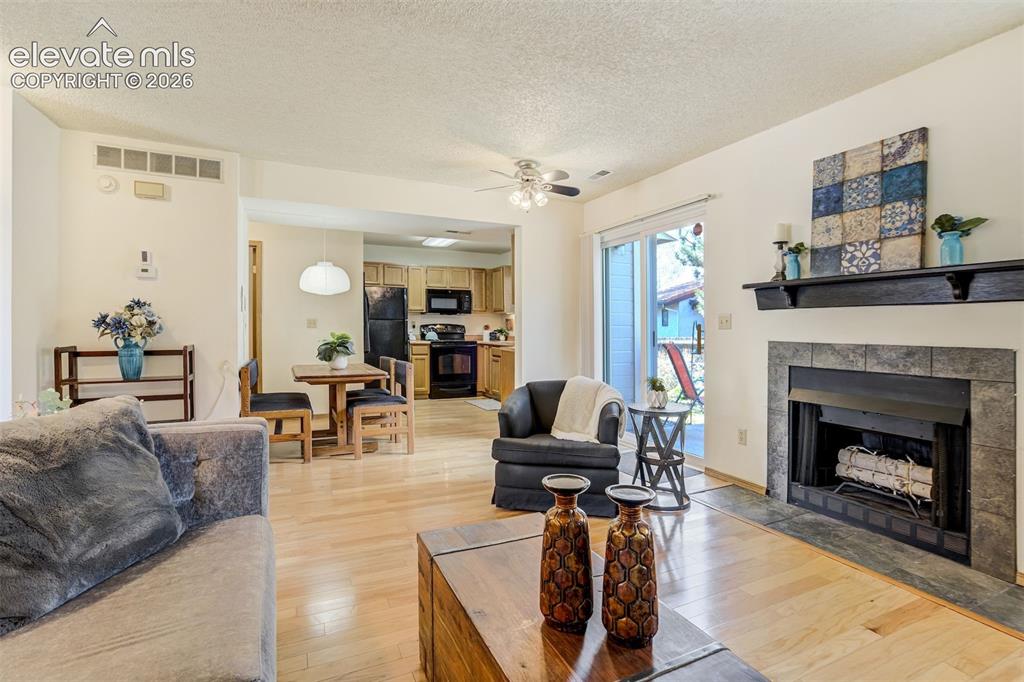 Image 8 of 50: Hardwood-finish flooring, built-in fireplace with stone surround, recessed 