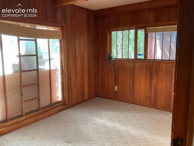 Image 31 of 36: Wood paneling on walls and ceiling beams