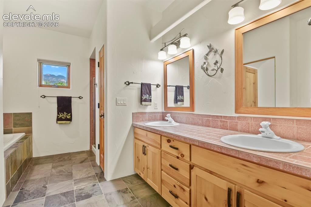 Image 14 of 39: 5 piece bath with slate floors