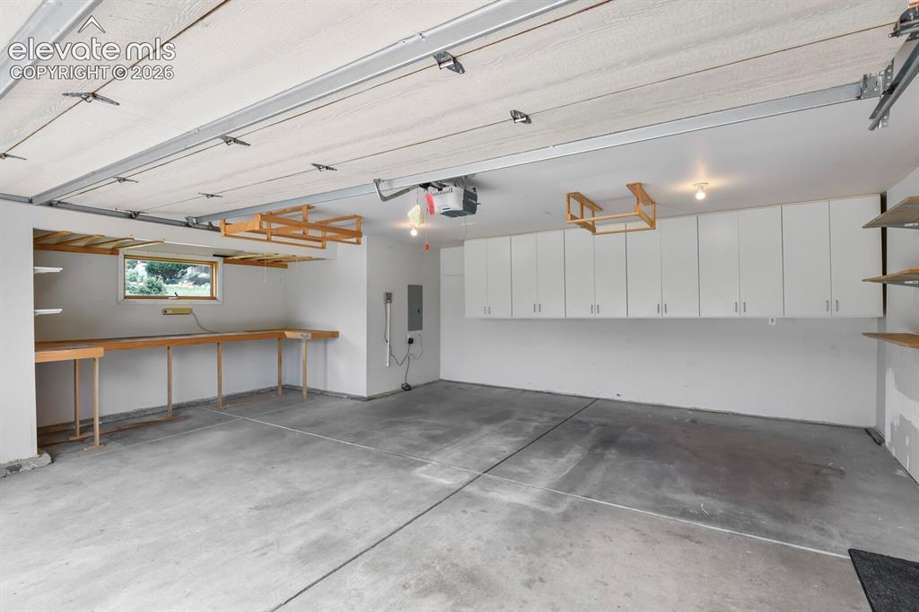 Image 26 of 39: Oversized 2 car with workbench & storage cabinets