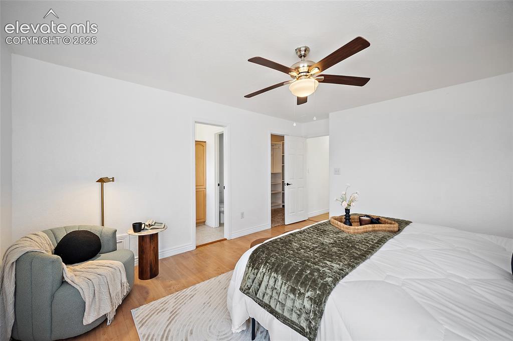 Image 13 of 40: Spacious room featuring light wood-finish flooring, a ceiling fan with inte