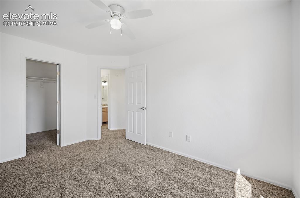 Image 17 of 40: Carpeted interior room featuring a white ceiling fan with integrated lighti