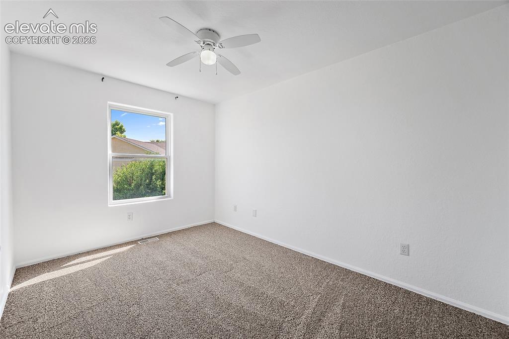 Image 18 of 40: Bright interior space featuring a window, textured carpet flooring, white w