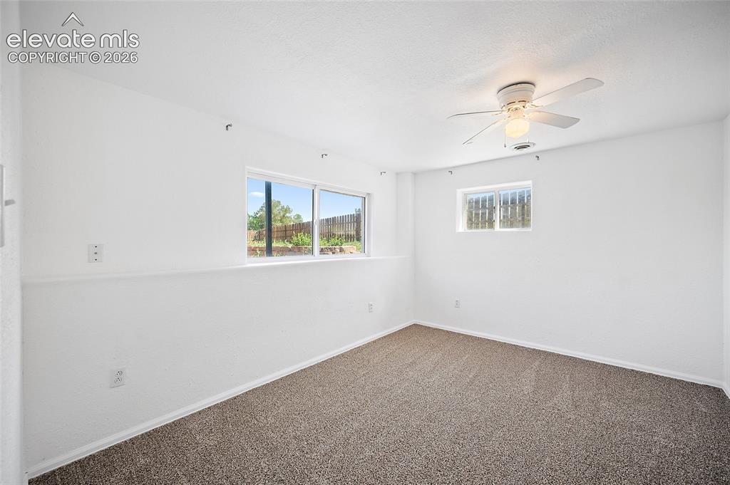 Image 25 of 40: Bright room featuring clean white walls, neutral carpet flooring, a ceiling