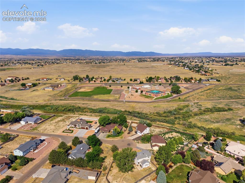 Image 37 of 40: Expansive aerial perspective showcasing a residential development amidst a 