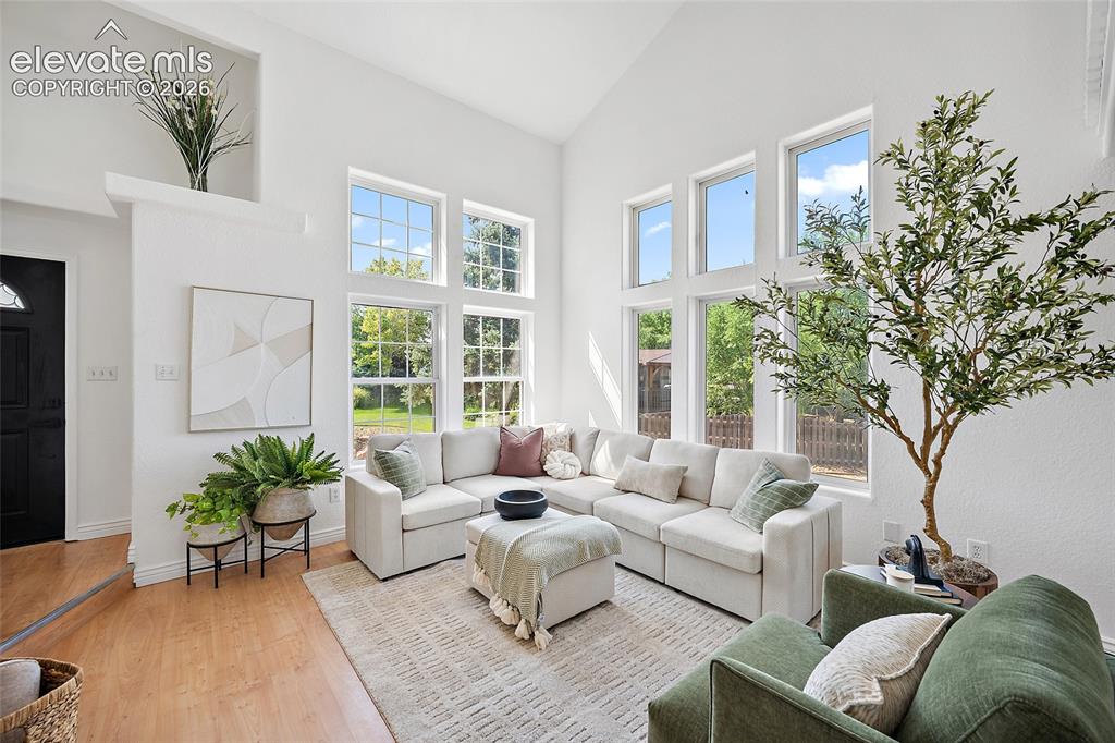 Image 5 of 40: Vaulted ceiling great room with abundant natural light, featuring multiple 