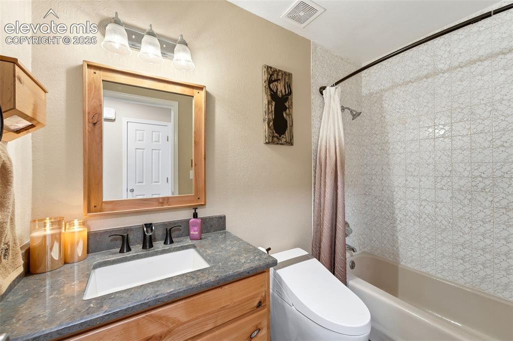 Image 14 of 42: Updated Full Hall Bath with smart toilet