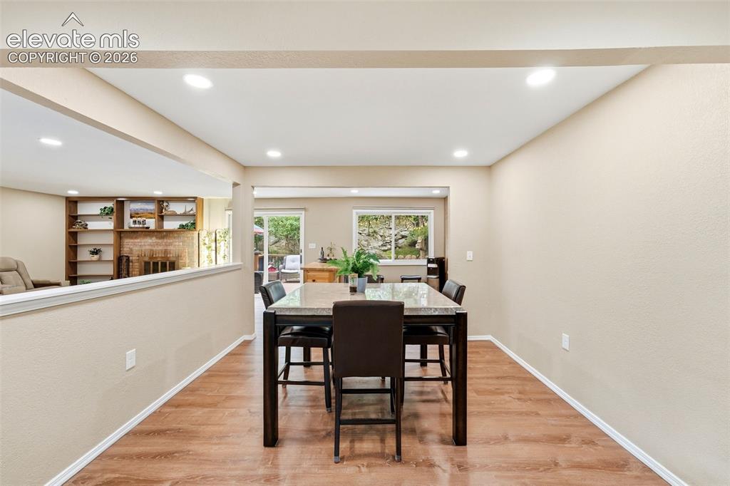 Image 23 of 42: Recessed lighting, wood-finish flooring, half-wall partition, built-in shel
