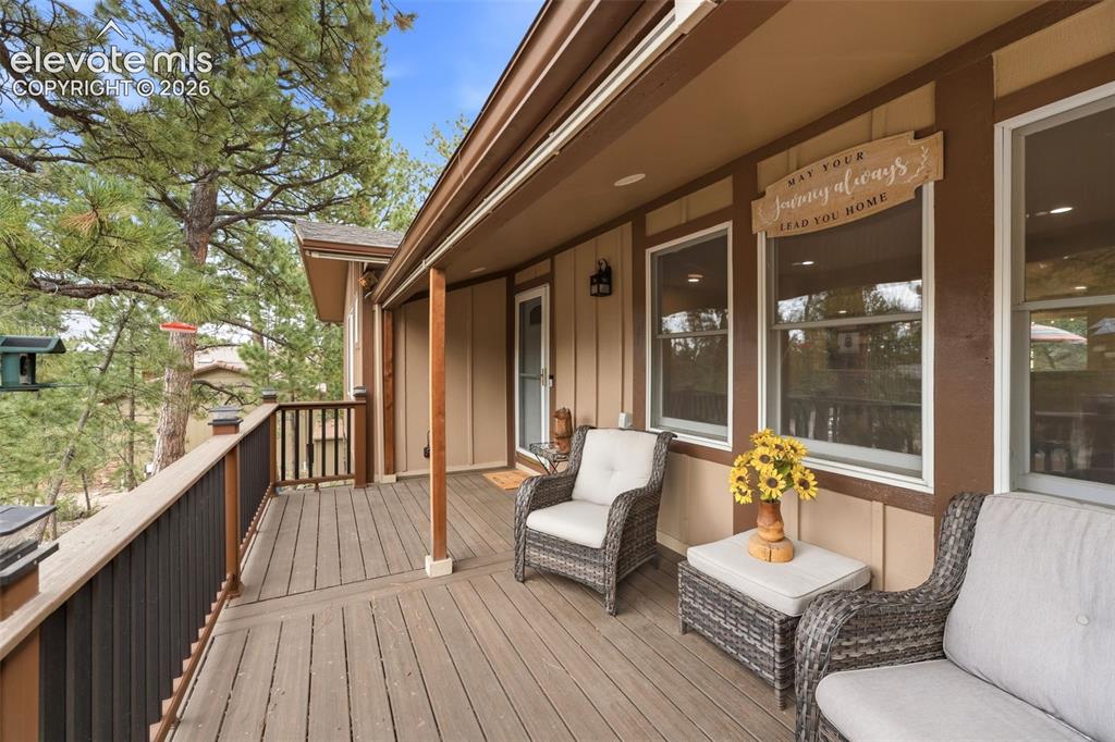 Image 3 of 42: Large covered front porch/deck with composite decking
