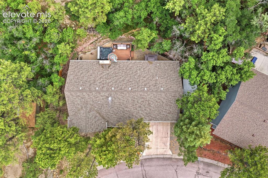 Image 40 of 42: Architectural shingle roof, integrated outdoor spa, and wood-finish decking