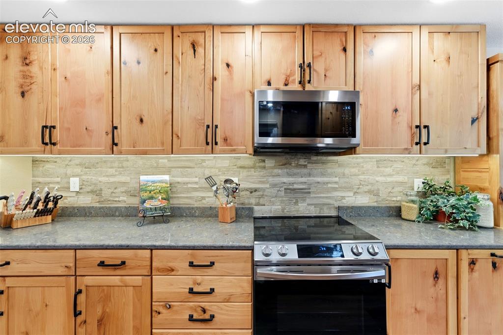Image 7 of 42: Induction stove top and built in combo microwave/convection