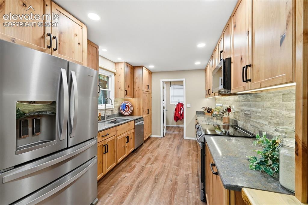 Image 9 of 42: Completely remodeled kitchen, stainless steel appliances, LVP flooring, sto