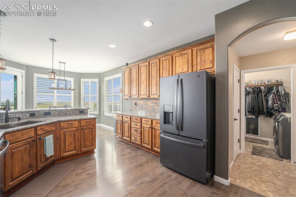Image 12 of 48: Kitchen featuring stainless steel refrigerator with ice dispenser, light st