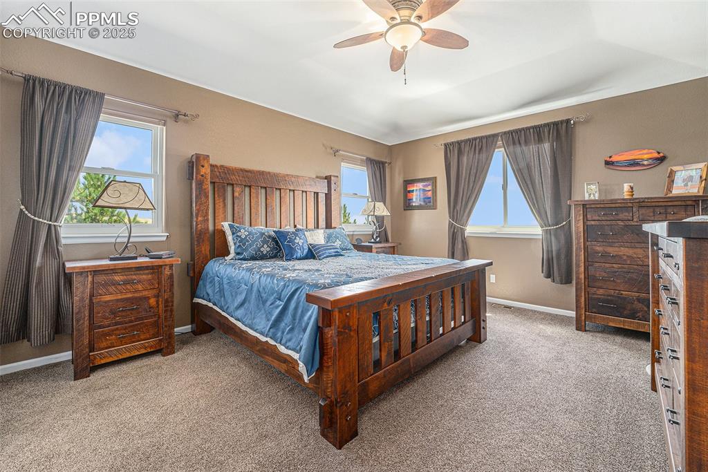 Image 13 of 48: Bedroom featuring light carpet and a ceiling fan
