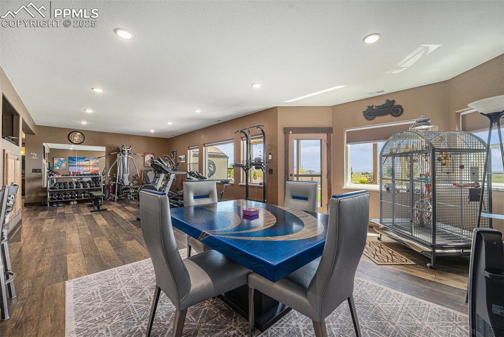 Image 29 of 48: Dining space with dark wood-type flooring and recessed lighting