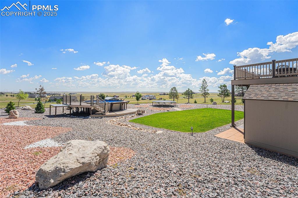 Image 38 of 48: View of grassy yard with a patio and a deck