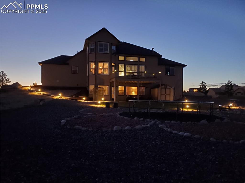 Image 45 of 48: Back of property with stucco siding and a balcony