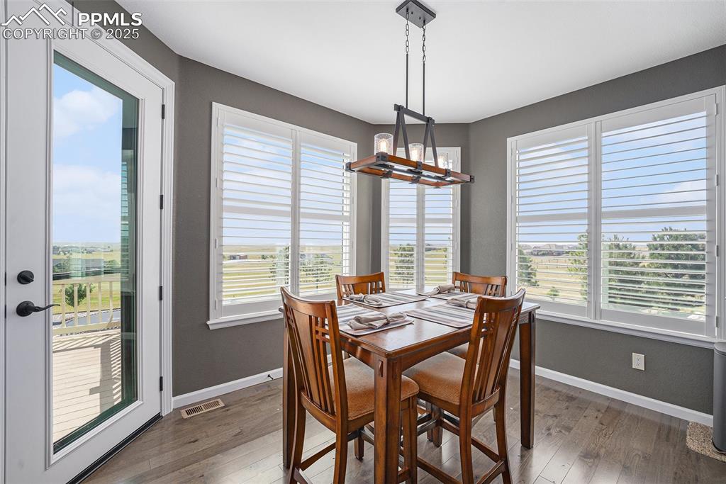 Image 7 of 48: Dining space featuring wood-type flooring and baseboards