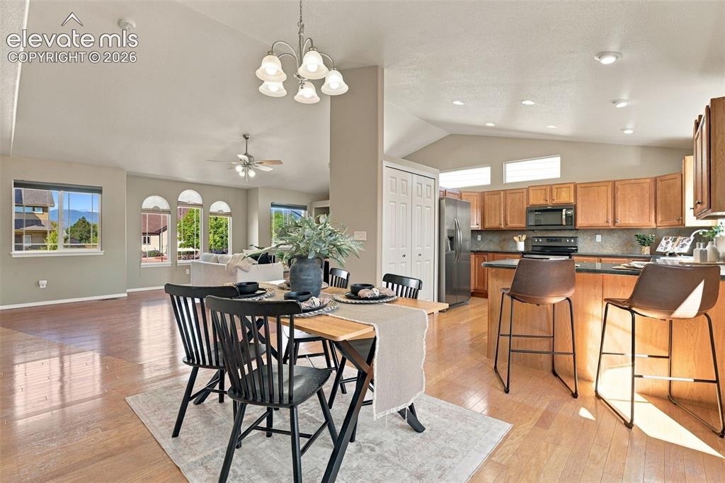 Image 17 of 50: Wood-finish flooring throughout, vaulted ceilings, kitchen with wood cabine