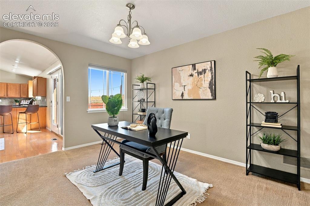 Image 20 of 50: Recessed lighting, arched doorway, kitchen with wood-finish cabinetry, hard