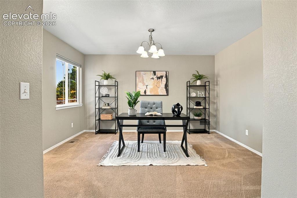 Image 22 of 50: Recessed lighting and a multi-light chandelier illuminate this space featur