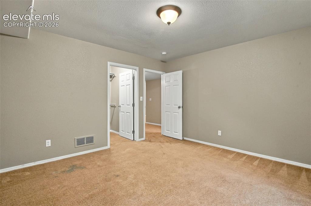 Image 40 of 50: Carpeted flooring, neutral wall color, ceiling-mounted light fixture, white
