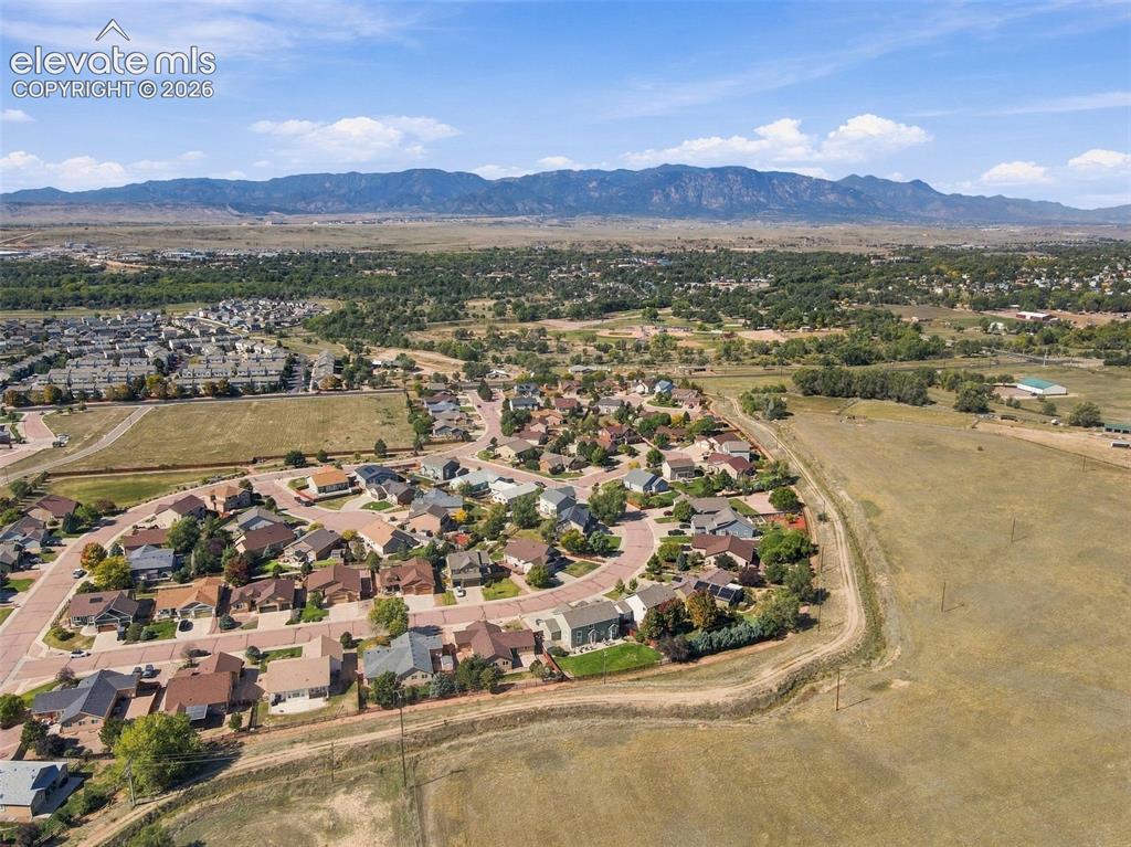 Image 43 of 50: Aerial perspective showcasing a residential community with distant mountain
