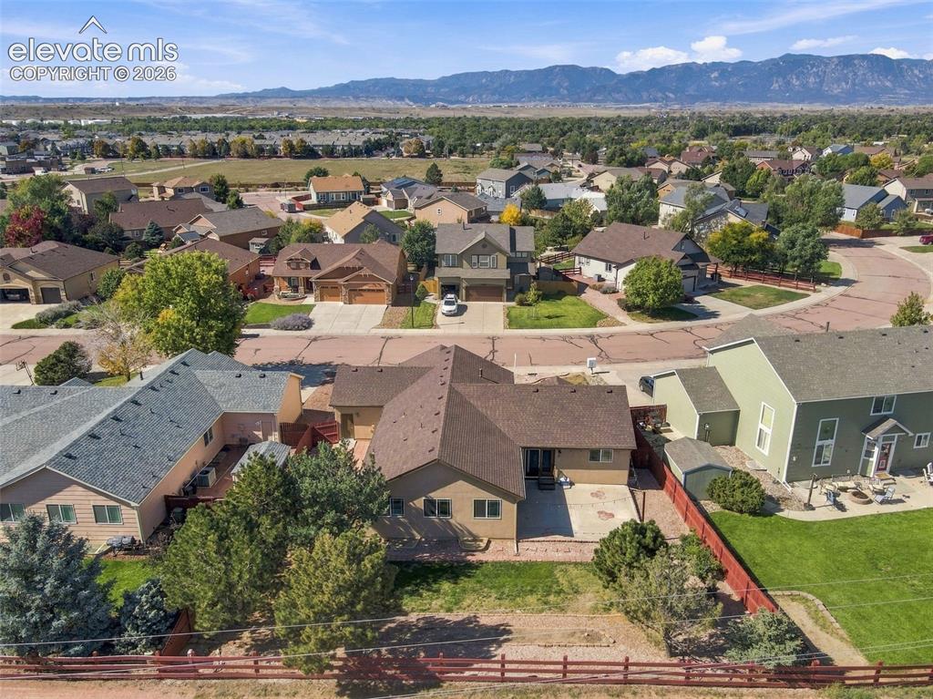 Image 44 of 50: Residential neighborhood with mountain backdrop