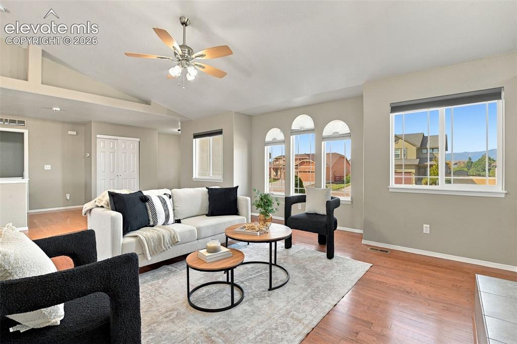 Image 6 of 50: Vaulted ceilings with a ceiling fan, wood-finish flooring, multiple arched