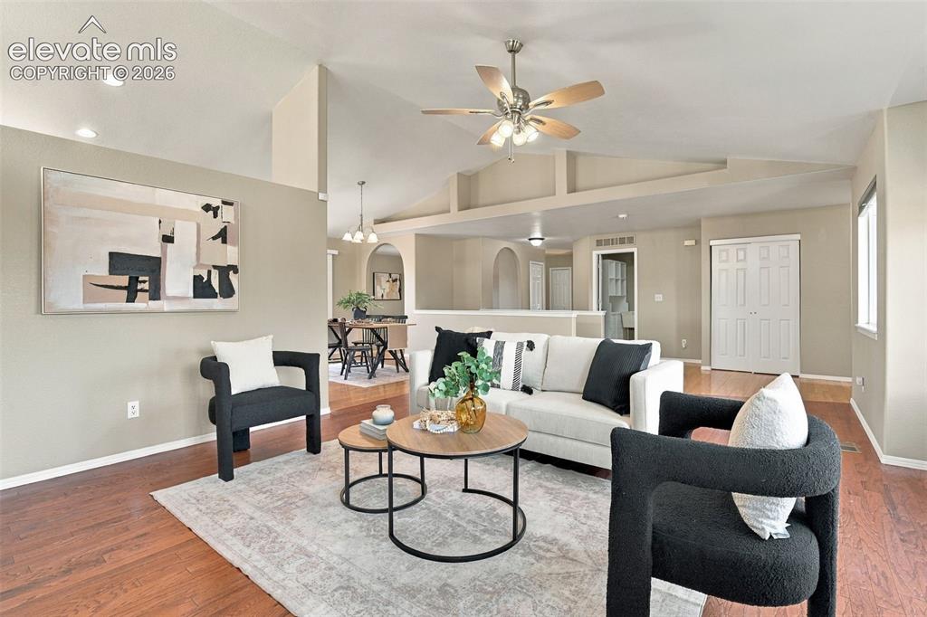 Image 7 of 50: Vaulted ceiling with a ceiling fan, hardwood flooring, recessed lighting, a