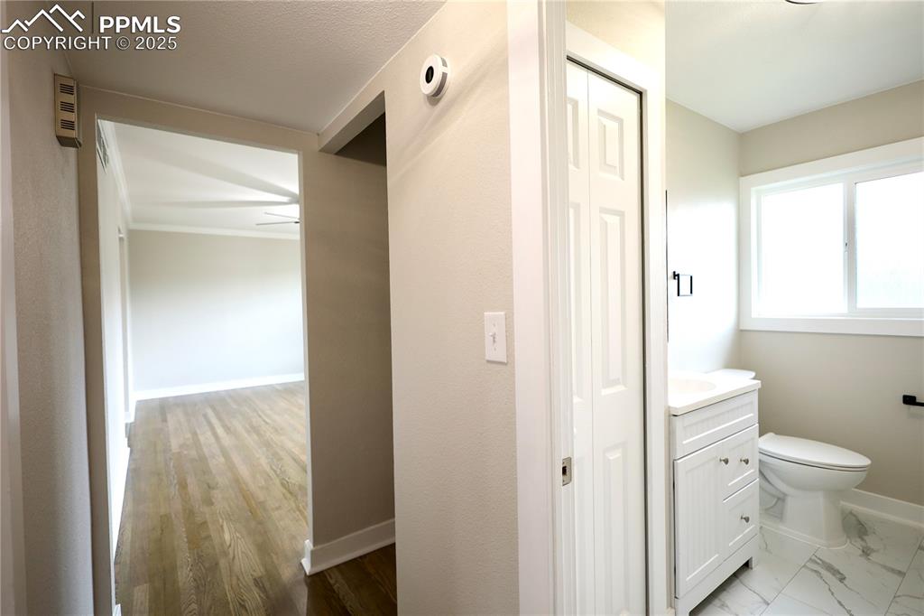 Image 14 of 27: Half bath featuring vanity and baseboards
