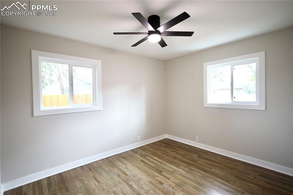 Image 15 of 27: Spare room featuring wood finished floors and ceiling fan