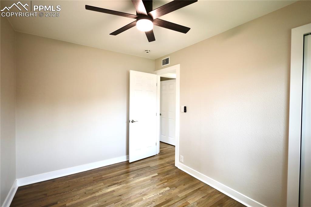 Image 16 of 27: Unfurnished bedroom featuring wood finished floors and ceiling fan
