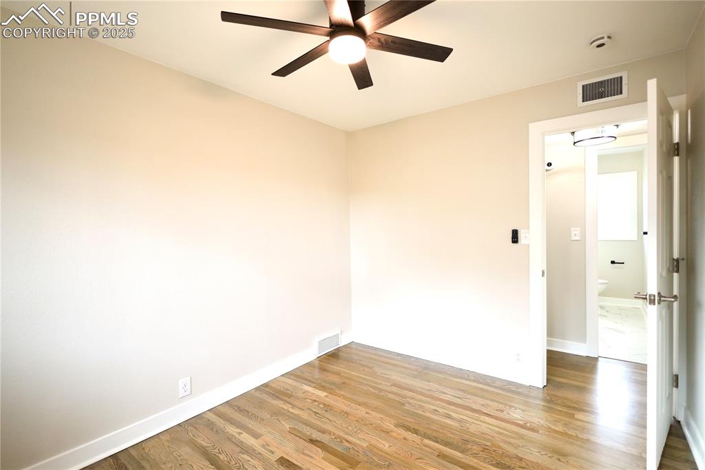 Image 17 of 27: Spare room featuring wood finished floors and a ceiling fan