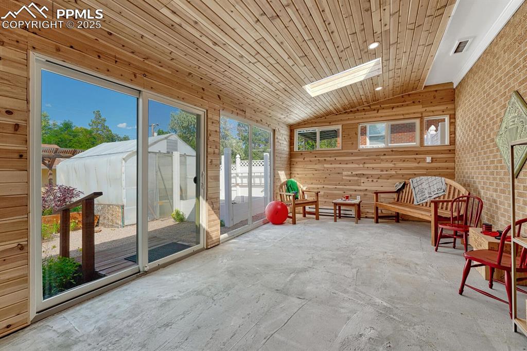 Image 16 of 50: Heated Sun Room with skylights