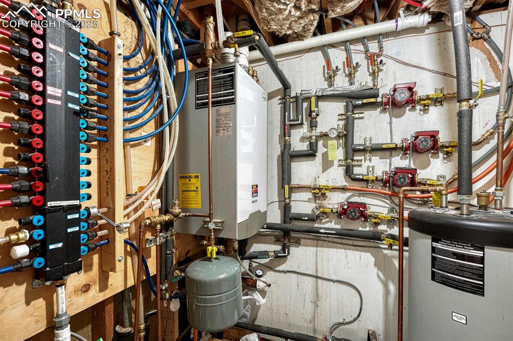 Image 38 of 50: Mechanical room showing PEX plumbing, gas-fired boiler for radiant floor he