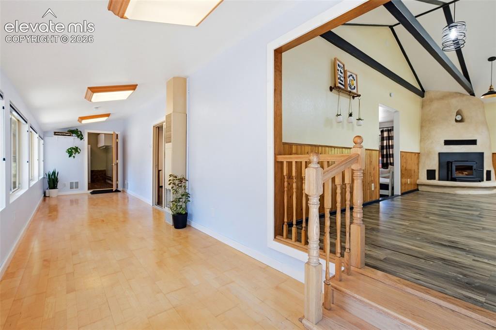Image 19 of 50: Corridor with wood-finish flooring, recessed lighting, and a window wall, o