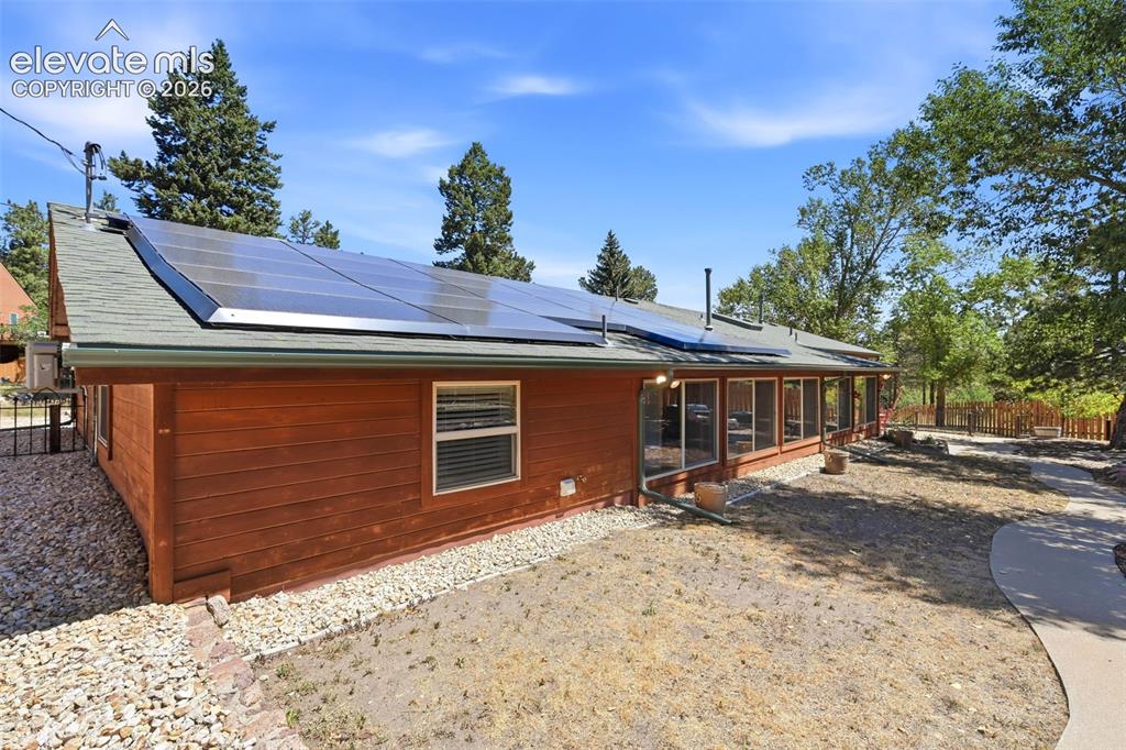 Image 41 of 50: Wood-sided residential structure featuring a screened-in porch, multiple so