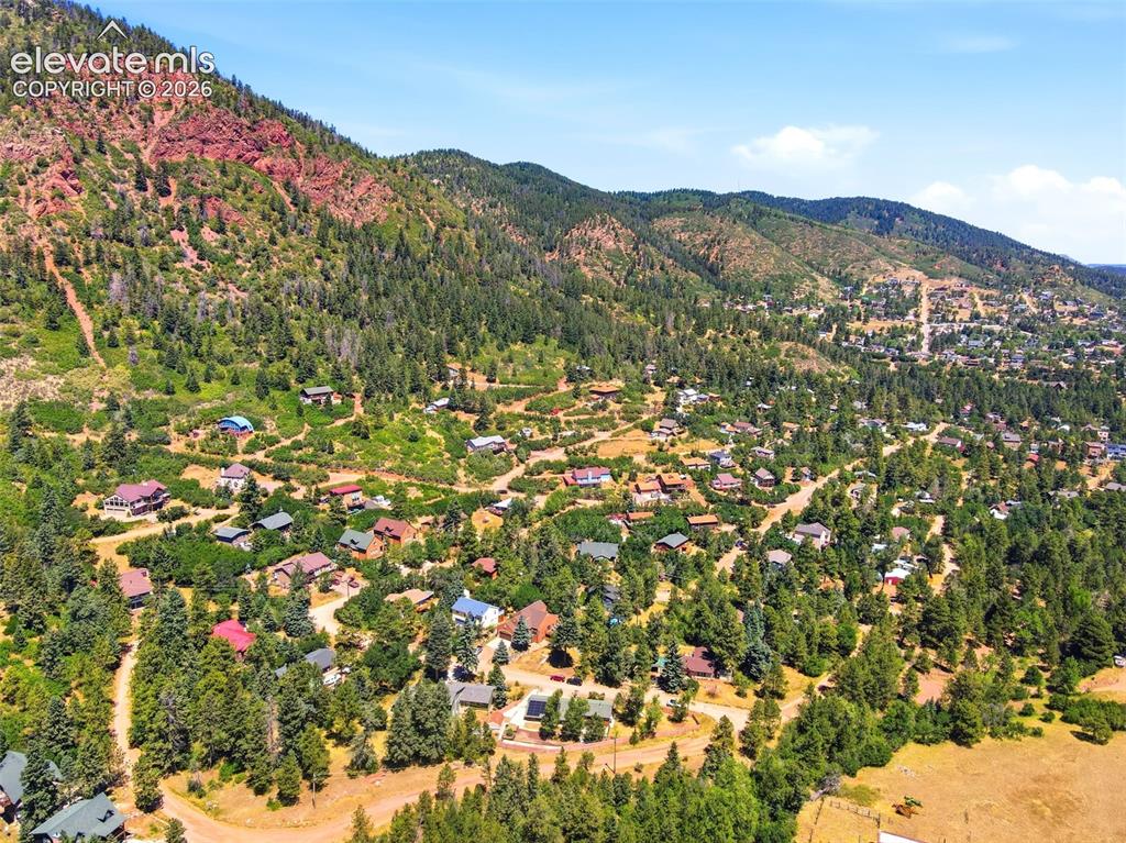 Image 47 of 50: Scenic mountain community featuring varied architectural styles and mature 