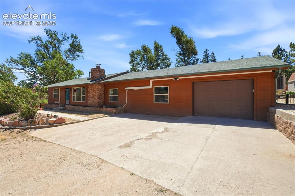 Image 49 of 50: Ranch-style exterior with brown siding and a stone accent facade