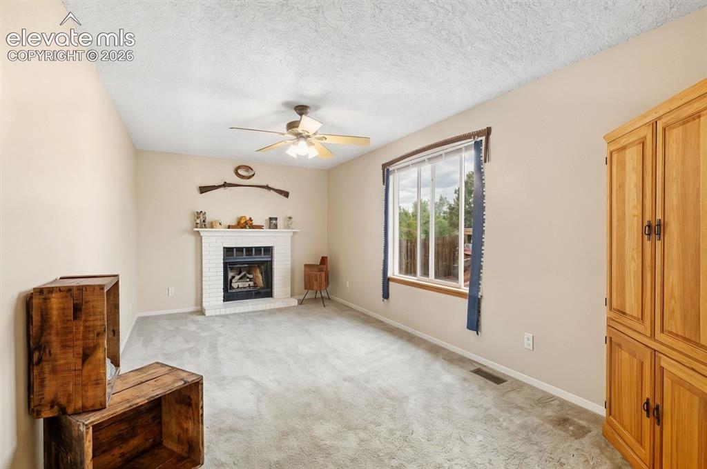 Image 10 of 28: Cozy up by the fireplace in the family room