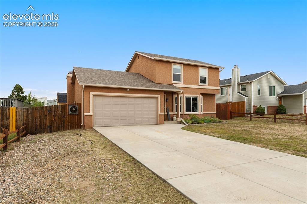 Image 2 of 28: Spacious front yard with stunning views of Pikes Peak