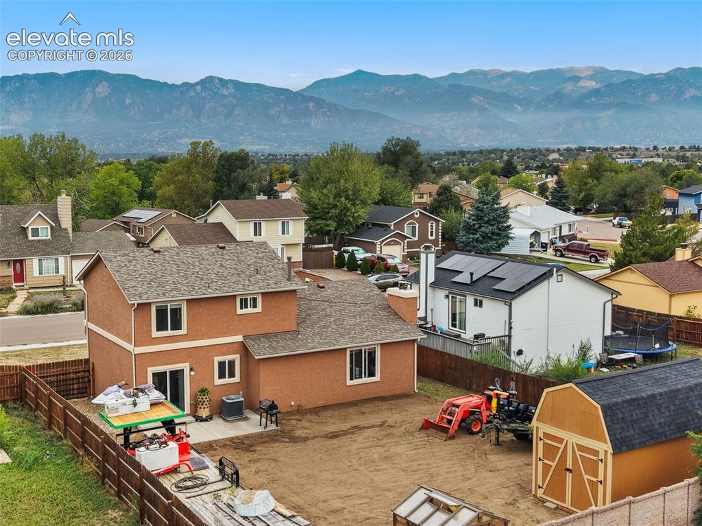 Image 3 of 28: Aerial view featuring the large backyard with gorgeous Pikes Peak views
